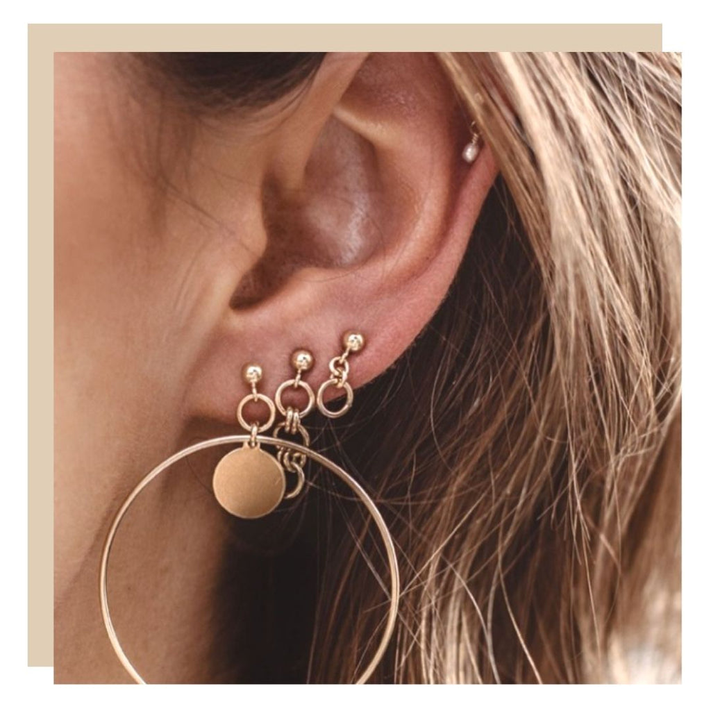 Stacking earrings with moon earrings and star earrings on female model ear. stack hoop earrings, thread through and studs together. Boho style jewellery tips and how to, shop Luna Tales Australia Online