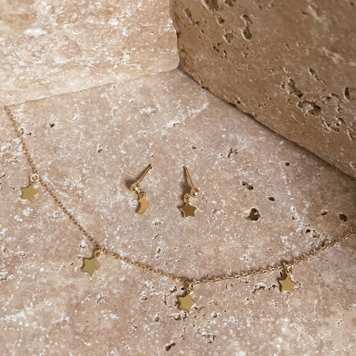 Stellar Necklace star necklace gold chain boho lifestyle on sandstone